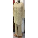 1970s Fashion: Cream crochet trouser suit. Long tunic top, long sleeves, round neck. Straight