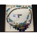 Costume Jewellery: Iridescent glass bead and block section necklace in an art deco style, with a