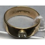 Hallmarked Gold: 9ct. Plain D section wedding band set with raised rub-over. 0·25ct. round brilliant