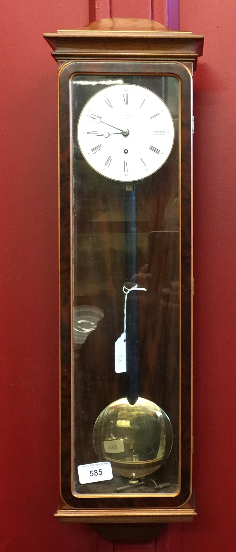 20th cent. Wall clock, mahogany and glass case. Erwin Sattler, Manchester. 6ins. x 24ins. x 3½ins.