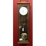 20th cent. Wall clock, mahogany and glass case. Erwin Sattler, Manchester. 6ins. x 24ins. x 3½ins.