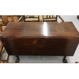 19th cent. Mahogany drop leaf table on turned supports rising off ball and claw feet.