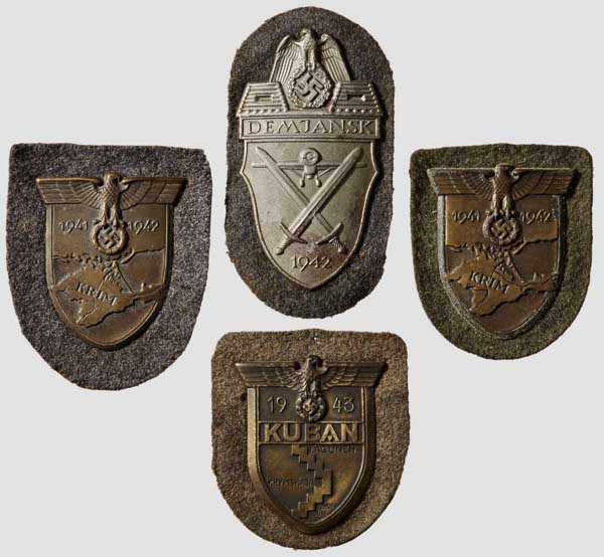 Four Campaign Shields Sleeve shields {Kuban{, {Demjansk{ and two {Krim{. All on field gray army
