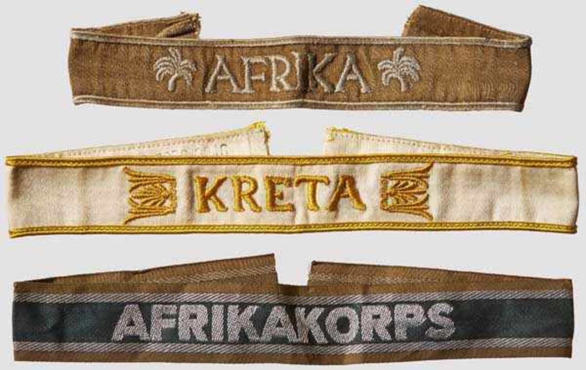 A Group of Three Campaign Cuff Titles Kreta, subtly ribbed, woven, white, cotton/rayon blend