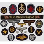 A Grouping of Military Insignia An M. G. Wilhelm Guftloff {KDF{ cap tally, gilt wire naval breast