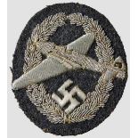 An NSFK 1st Model Motor-Powered Pilot's Badge Embroidered silver wire thread on blue gray wool