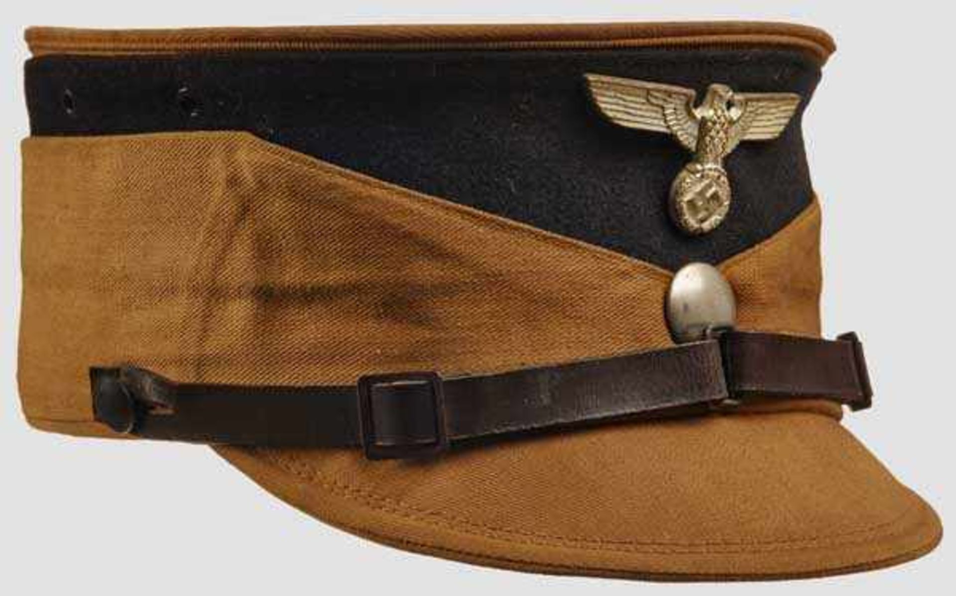 A Kepi for Officer of the SA Tan ribbed cotton body and visor, black wool band, silvered eagle,