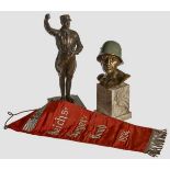 A Grouping of Two Figures and Table Banner Bronze-colored bust of Wehrmacht soldier, painted field