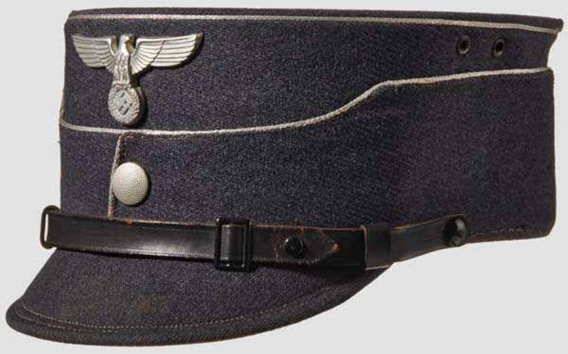 A Kepi for an NSFK Leader Blue gray body and visor (minor age), silver wire piping, aluminum eagle