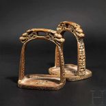 Ein Paar Steigbügel aus vergoldetem Kupfer, Tibet, 17. Jhdt. Jeweils gegossener, schwerer Steigbügel