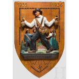 Gau 01 Baden, Nagelungsschild Erhaben geschnitztes Bild: Mann mit Glocken, im Hintergrund mehrere