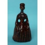 Victoria: a treacle glazed money box modelled as the Queen depicted full-length, circa 1838,