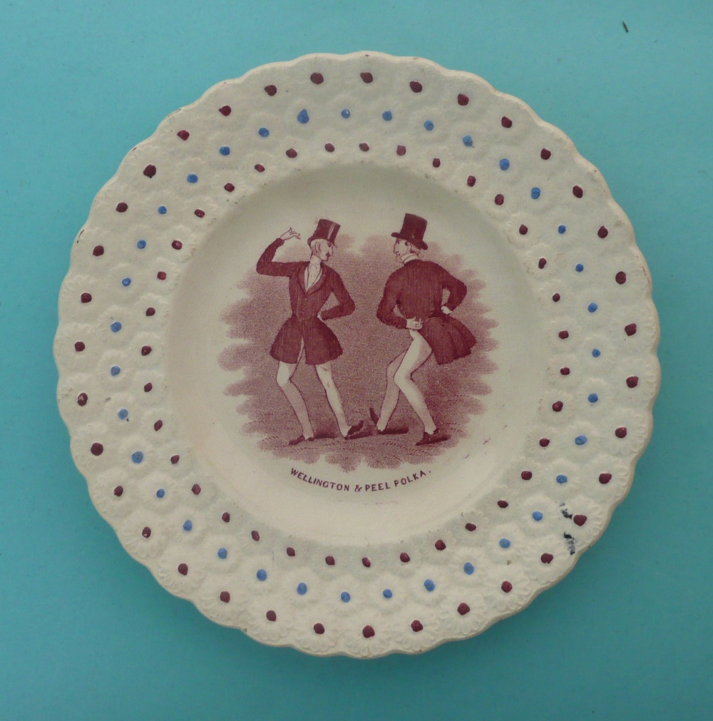 Wellington and Peel and the Polka: a good nursery plate with floret moulded border enamelled in blue