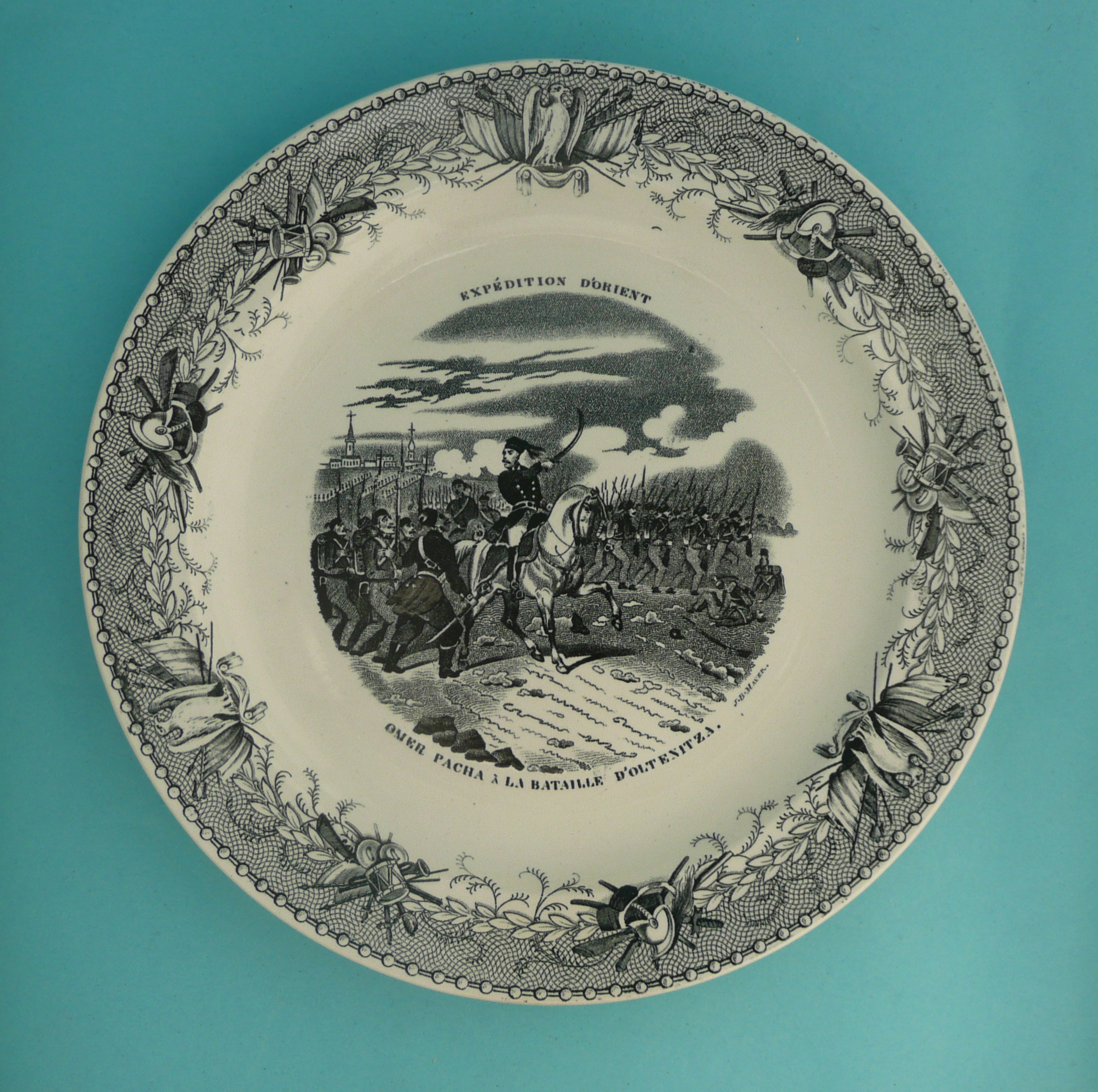 1853 Omar Pacha: a Belgian pottery plate printed in black with an inscribed battle scene of