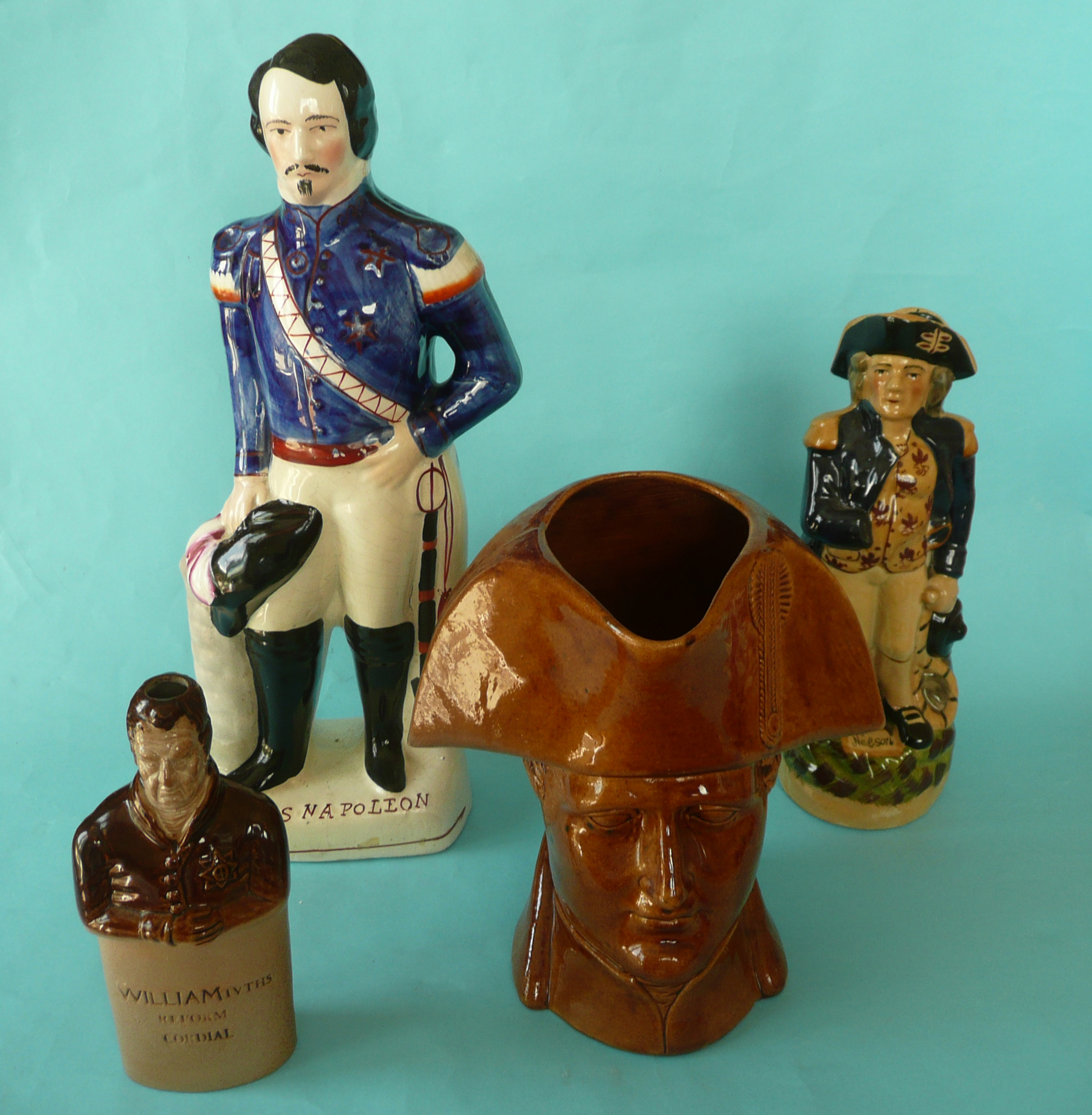 A brown glazed pottery maskhead pottery jug of Napoleon by George Skey, 230mm, handle repaired,