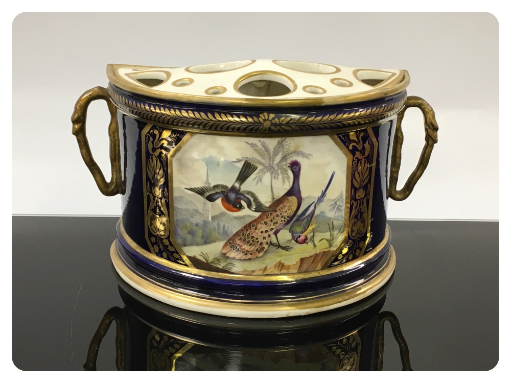 A CROWN DERBY HALF MOON ROSE BOWL PAINTED WITH EXOTIC BIRD PANEL WITHIN GILT BORDERS ON A BLUE