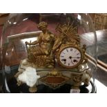 FRENCH GILT AND ONYX MANTEL CLOCK ADORNED WITH A SEATED FIGURE, HARVEST TOOLS AND EARS OF CORN,