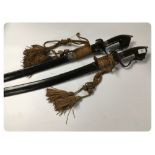 A PAIR OF MOROCCAN NIMCHA STYLE SWORDS IN SIMILAR LEATHER BOUND SCABBARDS A/F CONDITIONS WITH POOR