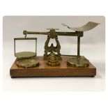 A BRASS SET OF PARCEL POSTAL SCALES AND WEIGHTS BY S. MORDAN & CO.