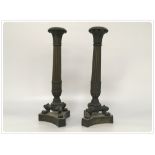 A PAIR OF BRONZE CANDLESTICKS (ONE LACKING COLLAR)