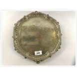 A SOLID SILVER SALVER STANDING ON A BALL AND CLAW FOOT, THE TOP ENGRAVED WITH FRUIT MEDALLIONS,