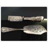 SILVER FISH SLICE LONDON 1853 ALONG WITH A PAIR OF SPRUNG SILVER CAKE TONGS LONDON ASSAY