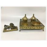 A FOUR PIECE HEAVY BRASS DESK SET ON ASSOCIATED STAND ALONG WITH A BRASS MYTHICAL HORSE PAPER