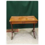 19TH CENTURY MAHOGANY WRITING TABLE WITH CONCEALED DRAWERS ON A DOWN-SWEPT SABRE LEG,
