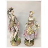 A PAIR OF LARGE C19TH GERMAN HARD PASTE FIGURES OF A MAN AND A WOMAN IN PERIOD DRESS BEARING BLUE