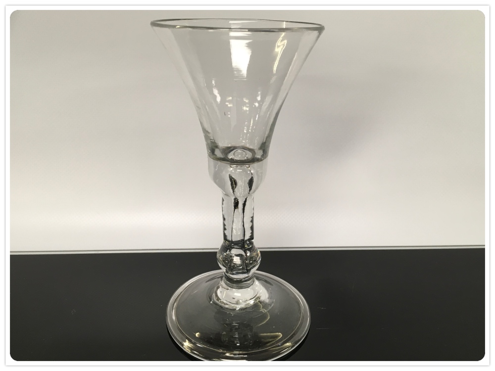 A GEORGIAN WINE GLASS WITH FOLDED FOOT,