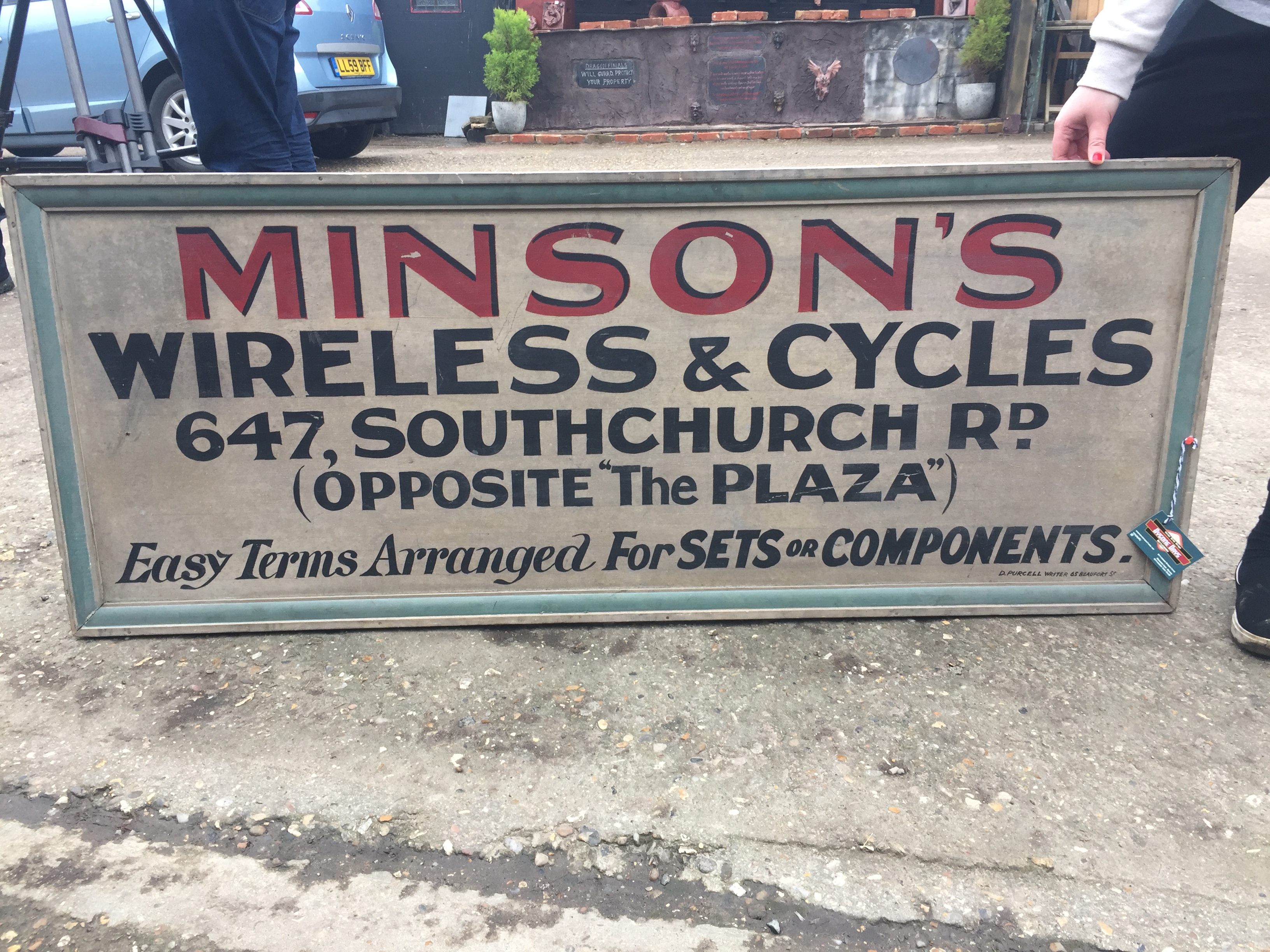 A 1950'S DOUBLE SIDED PAINTED WOODEN SIGN FOR "MINSONS" WIRELESS AND CYCLE SHOP