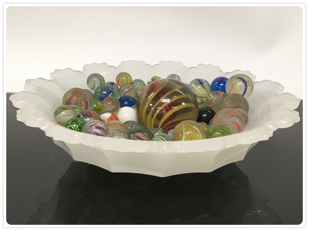 A VASELINE GLASS BOWL , ALONG WITH A GROUP OF ANTIQUE MARBLES,