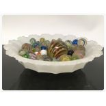 A VASELINE GLASS BOWL , ALONG WITH A GROUP OF ANTIQUE MARBLES,