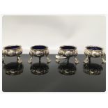 A SET OF FOUR C18TH SILVER TABLE SALTS WITH BLUE GLASS LINERS, LONDON 1757,