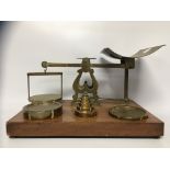 A BRASS SET OF PARCEL POSTAL SCALES AND WEIGHTS BY S. MORDAN & CO.