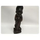 A CARVED FIGURE "THINKING MAN"