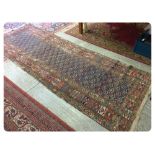 AN ANTIQUE KUBA RUG, 325 X 112 CM APPROX