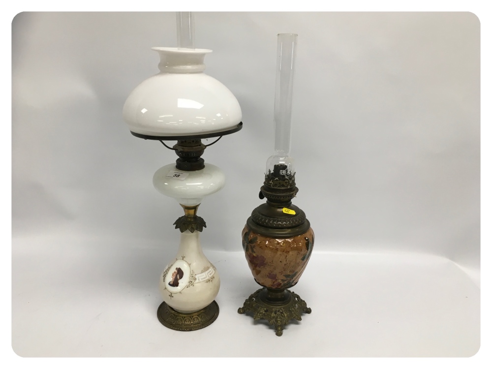 TWO OIL LAMPS, EACH WITH ORNATE METAL FI