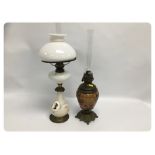 TWO OIL LAMPS, EACH WITH ORNATE METAL FI