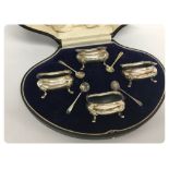 A CASED FOUR SILVER FOOTED SALTS BIRMIN