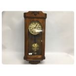 AN OAK REGULATOR STYLE WALL CLOCK WITH S