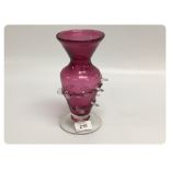 A CRANBERRY GLASS VASE WITH CLEAR FRILL
