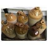 A COLLECTION OF SEVEN STONEWARE FLAGGONS