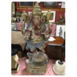 A PAINTED CARVED WOODEN FIGURE OF GANESH