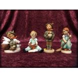 FOUR GOEBEL "HUMMEL" FIGURES, BOY WITH R