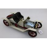 A Mamod live steam roadster, open top ivory coach work, complete with steering rod and burner,