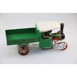A Mamod live steam wagon,with green coachwork, steering rod and burner, 40cm long