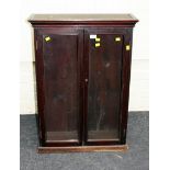 A Victorian mahogany bookcase, the moulded cornice over a pair of glazed doors enclosing two