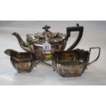 A three piece silver teaset, oval with canted corners, the teapot with domed fluted cover and