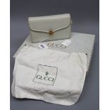 A Gucci cream small clutch back in box